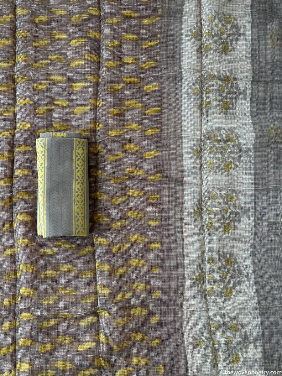 Grey and yellow Bagru Ajrakh hand block printed cotton suit set by Woven Poetry with Kota Doria dupatta and leaf motif
