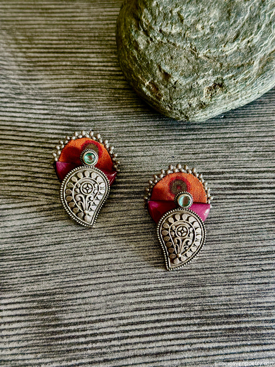 Handmade Ajrakh brass enamel paisley stud earrings with orange Ajrakh fabric
