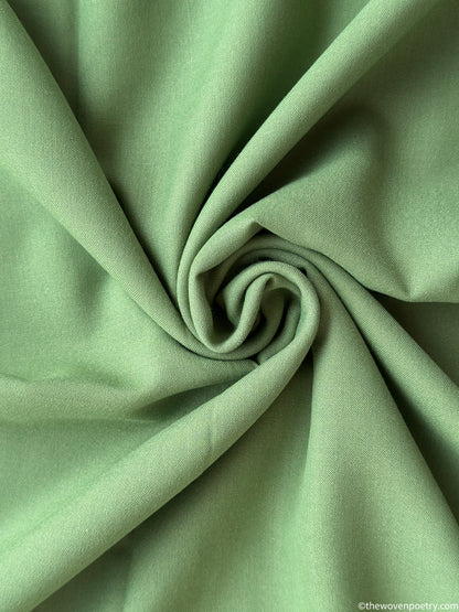 Close-up of green fabric by woven Poetry with folds