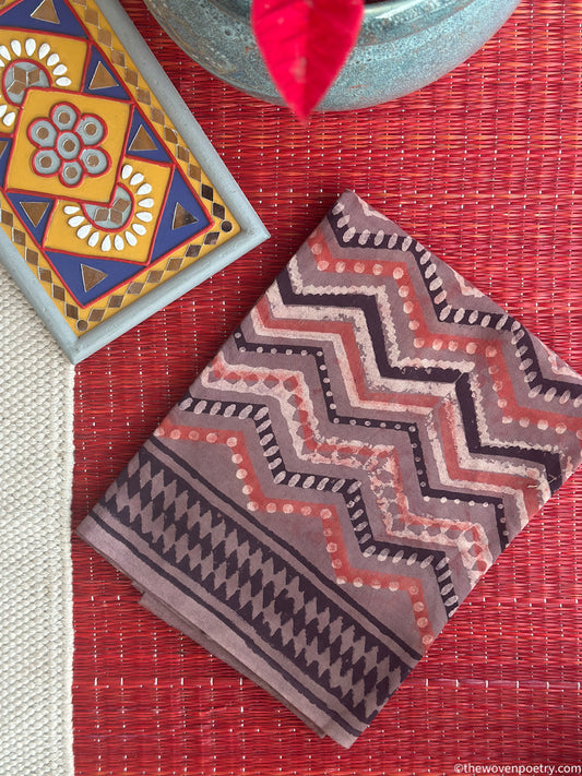 Folded view of Bagru Ajrakh hand block printed cotton suit set with Kota Doria dupatta in geometric pattern