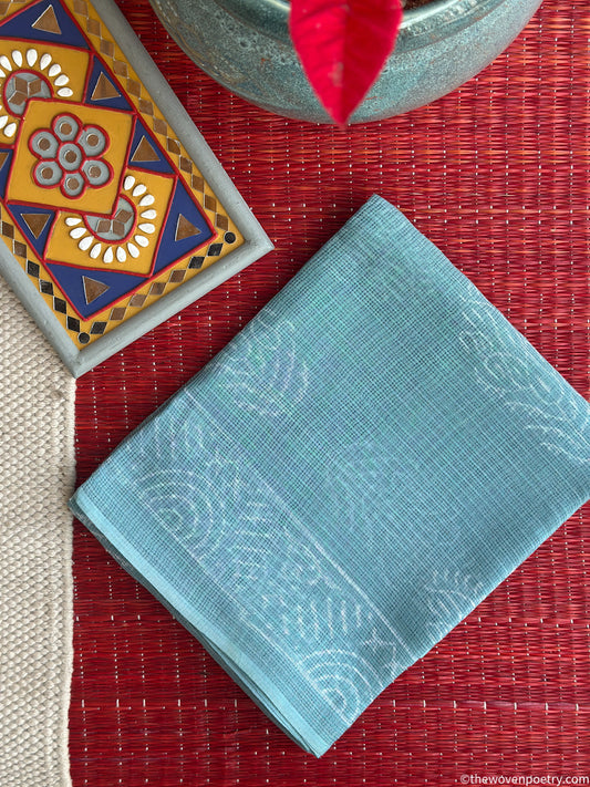 Folded view of sky blue Bagru hand block printed Kota Doria suit set by Woven Poetry
