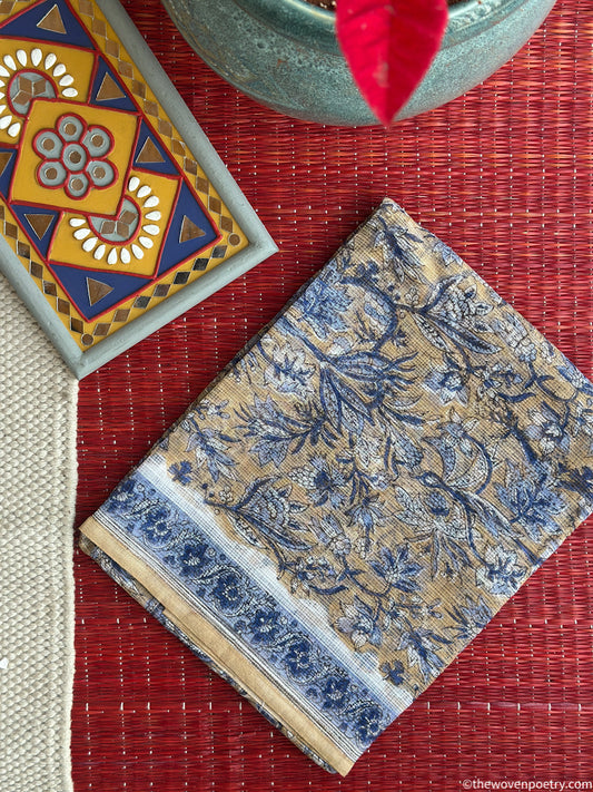 Folded view of mustard and blue Sanganeri Kota Doria suit set by Woven Poetry