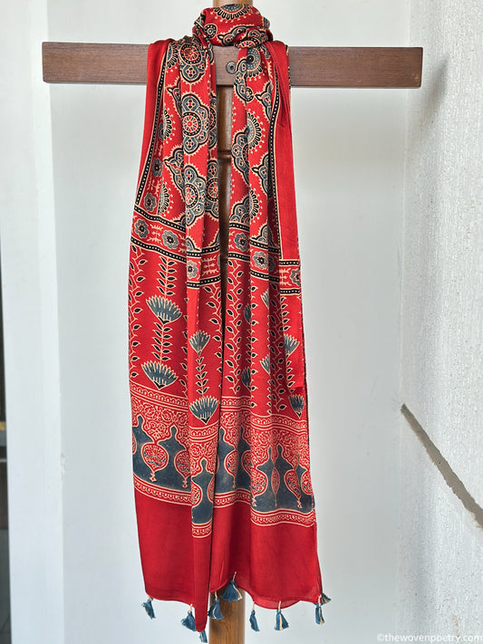Handcrafted red Ajrakh floral stole with blue and ivory border detailing by Woven Poetry