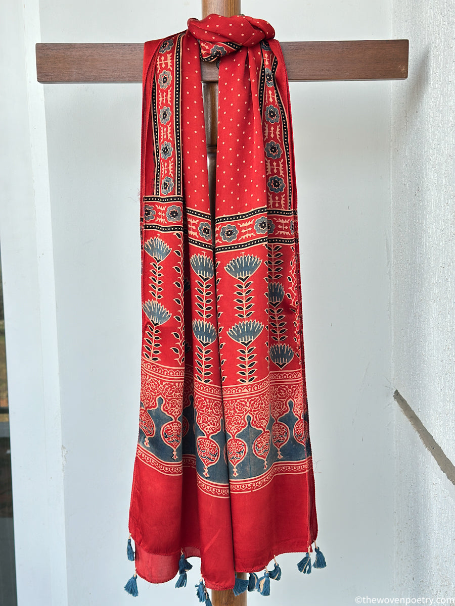 Handcrafted  red Ajrakh floral stole with blue and ivory border detailing by Woven Poetry