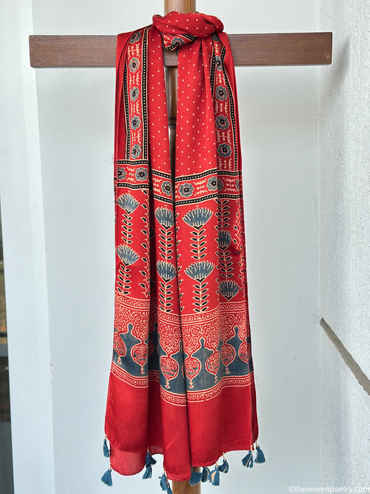 Handcrafted  red Ajrakh floral stole with blue and ivory border detailing by Woven Poetry