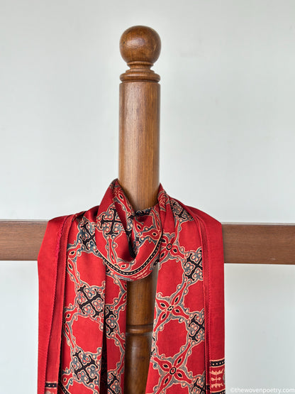 Handcrafted red modal silk Ajrakh  stole  with tassels by Woven Poetry