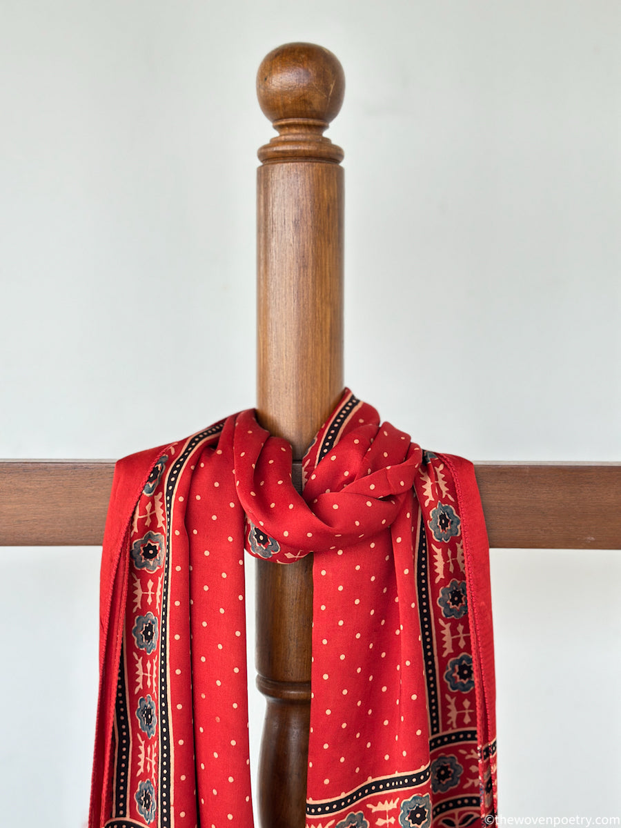 Handcrafted  red Ajrakh floral stole with blue and ivory border detailing by Woven Poetry