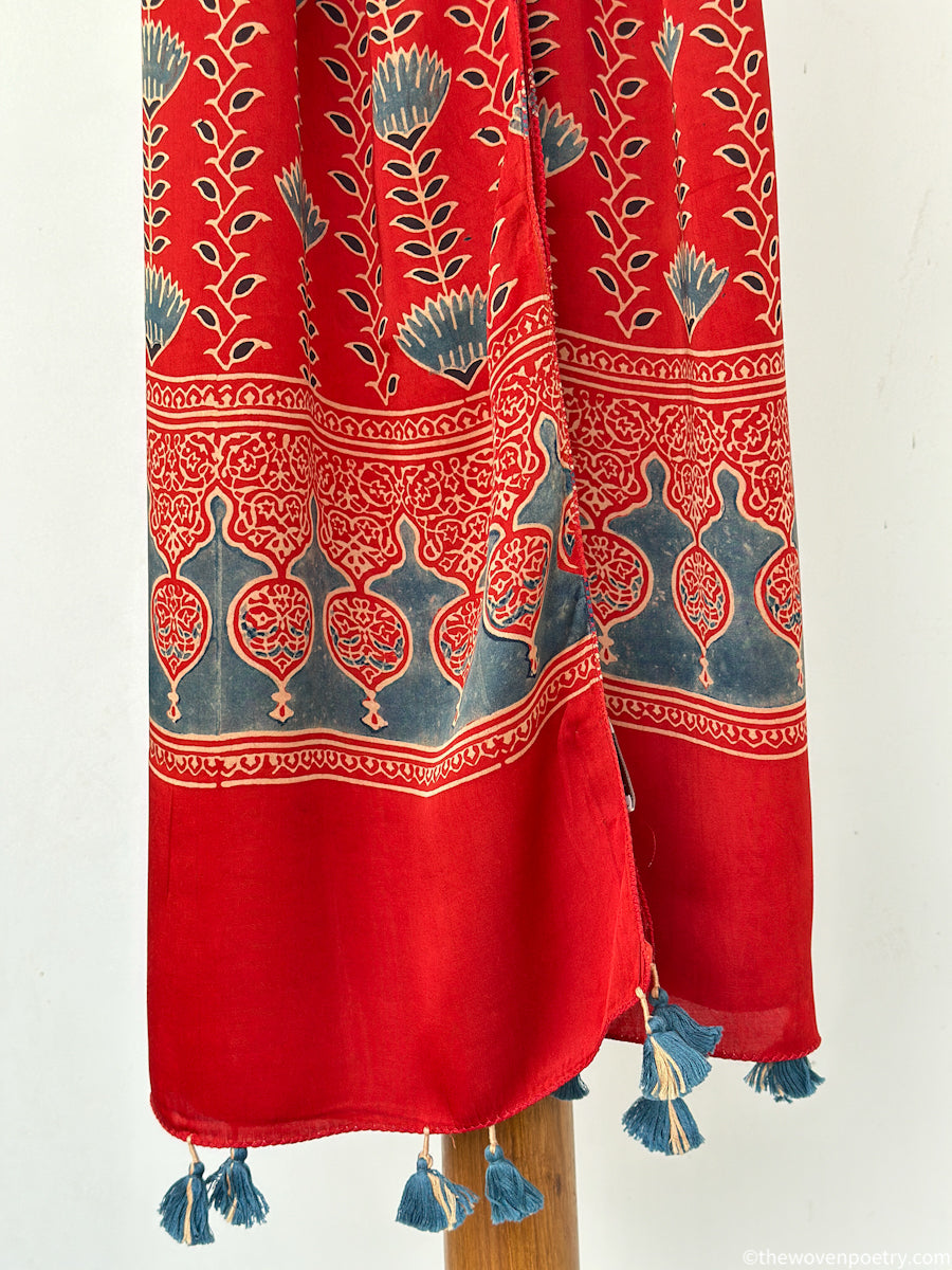 Handcrafted red Ajrakh floral stole with blue and ivory border detailing by Woven Poetry