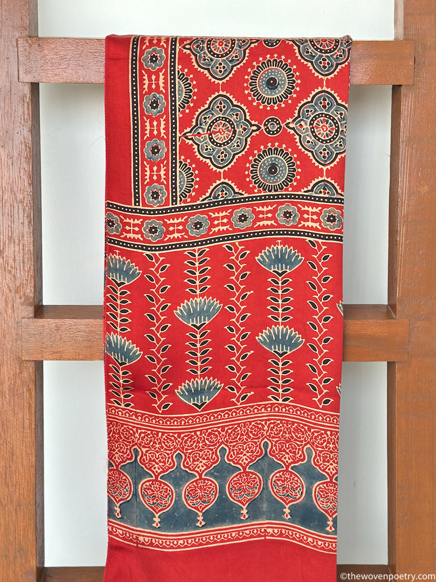 Handcrafted red Ajrakh floral stole with blue and ivory border detailing by Woven Poetry