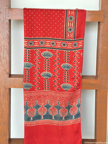 Handcrafted  red Ajrakh floral stole with blue and ivory border detailing by Woven Poetry