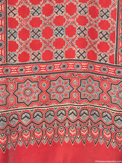 Handcrafted red modal silk Ajrakh  stole  with tassels by Woven Poetry