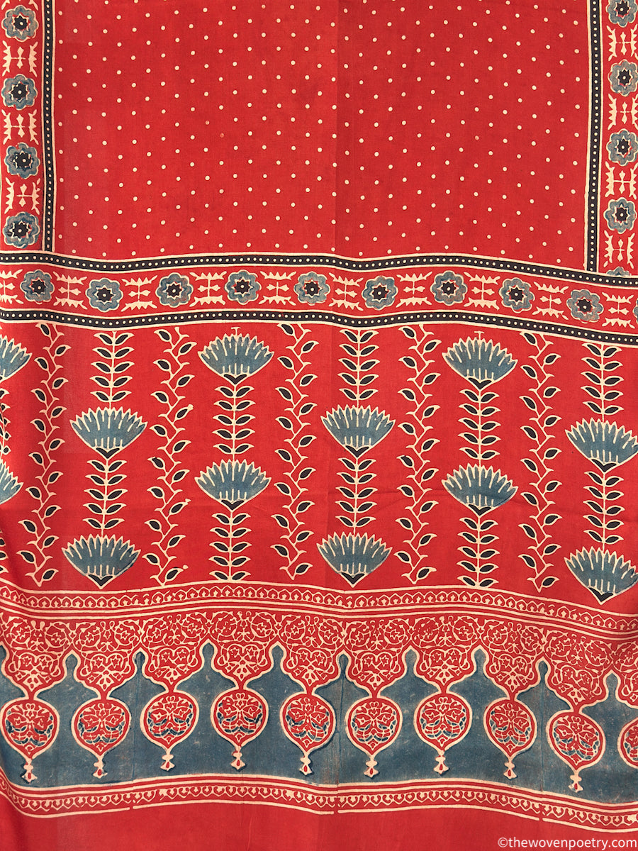 Handcrafted  red Ajrakh floral stole with blue and ivory border detailing by Woven Poetry