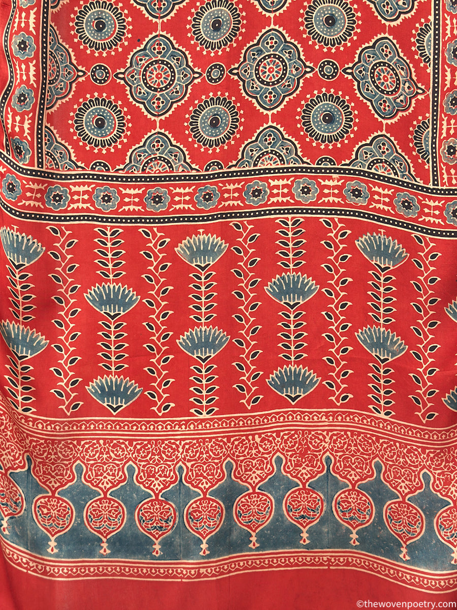 Handcrafted red Ajrakh floral stole with blue and ivory border detailing by Woven Poetry