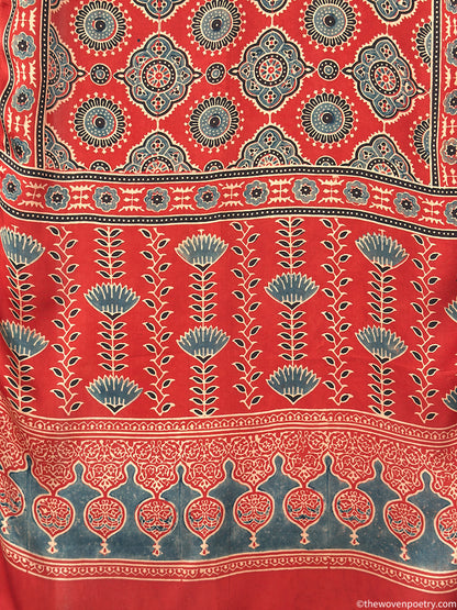 Handcrafted red Ajrakh floral stole with blue and ivory border detailing by Woven Poetry